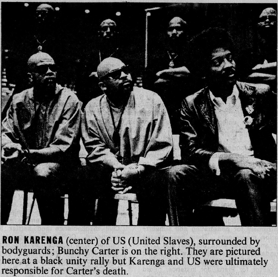 (Ron Karenga (center) of US (United Slaves), surrounded by 
				bodyguards; Bunchy Carter is on the right. They are pictured here at a 
				black unity rally but Karenga and US were ultimately responsible for 
				Carter's death.)